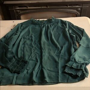 Elegant Green Blouse with Ruffled Neckline it’s lined.